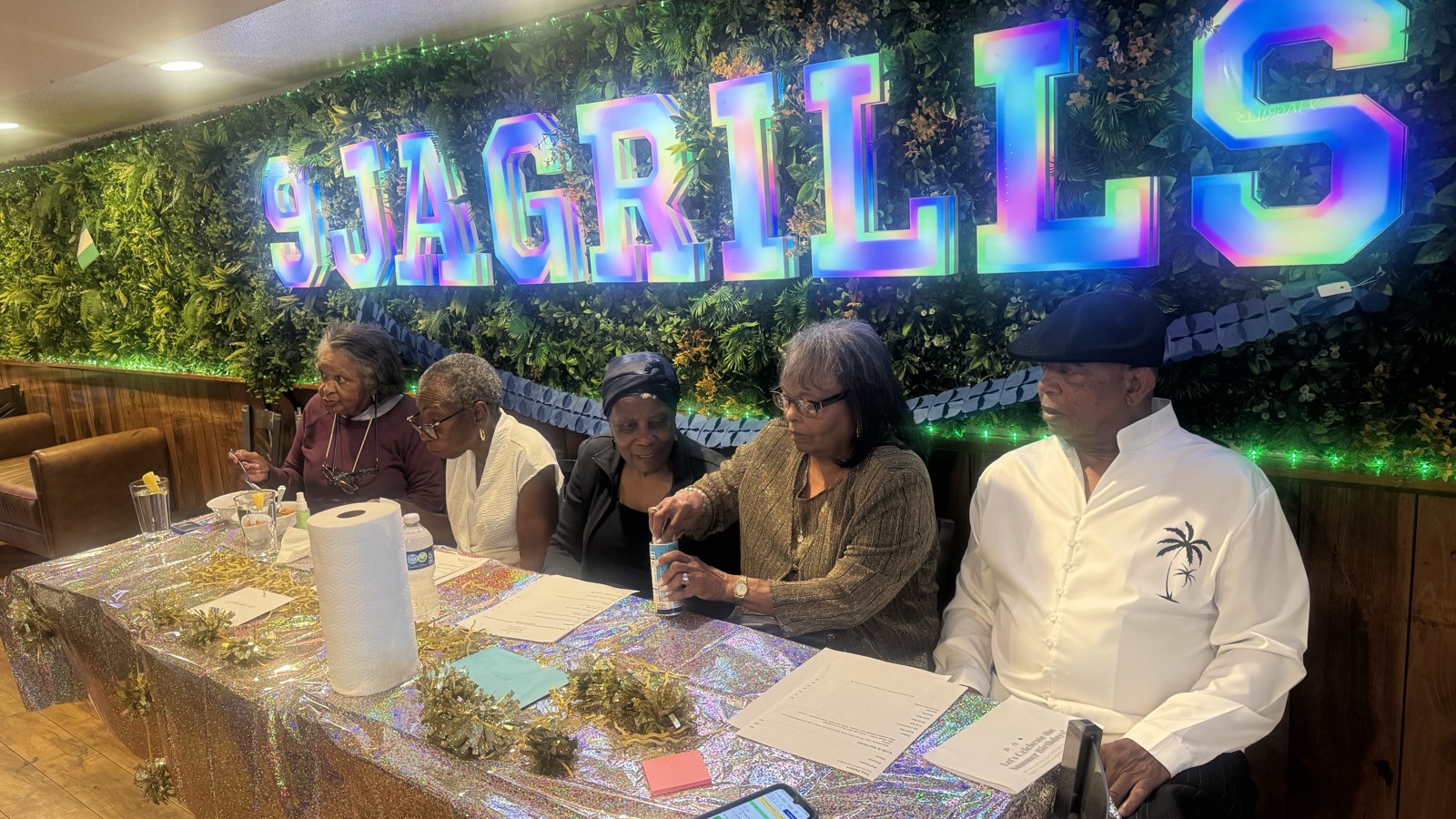 Guests seated together under the 9jaGrills sign